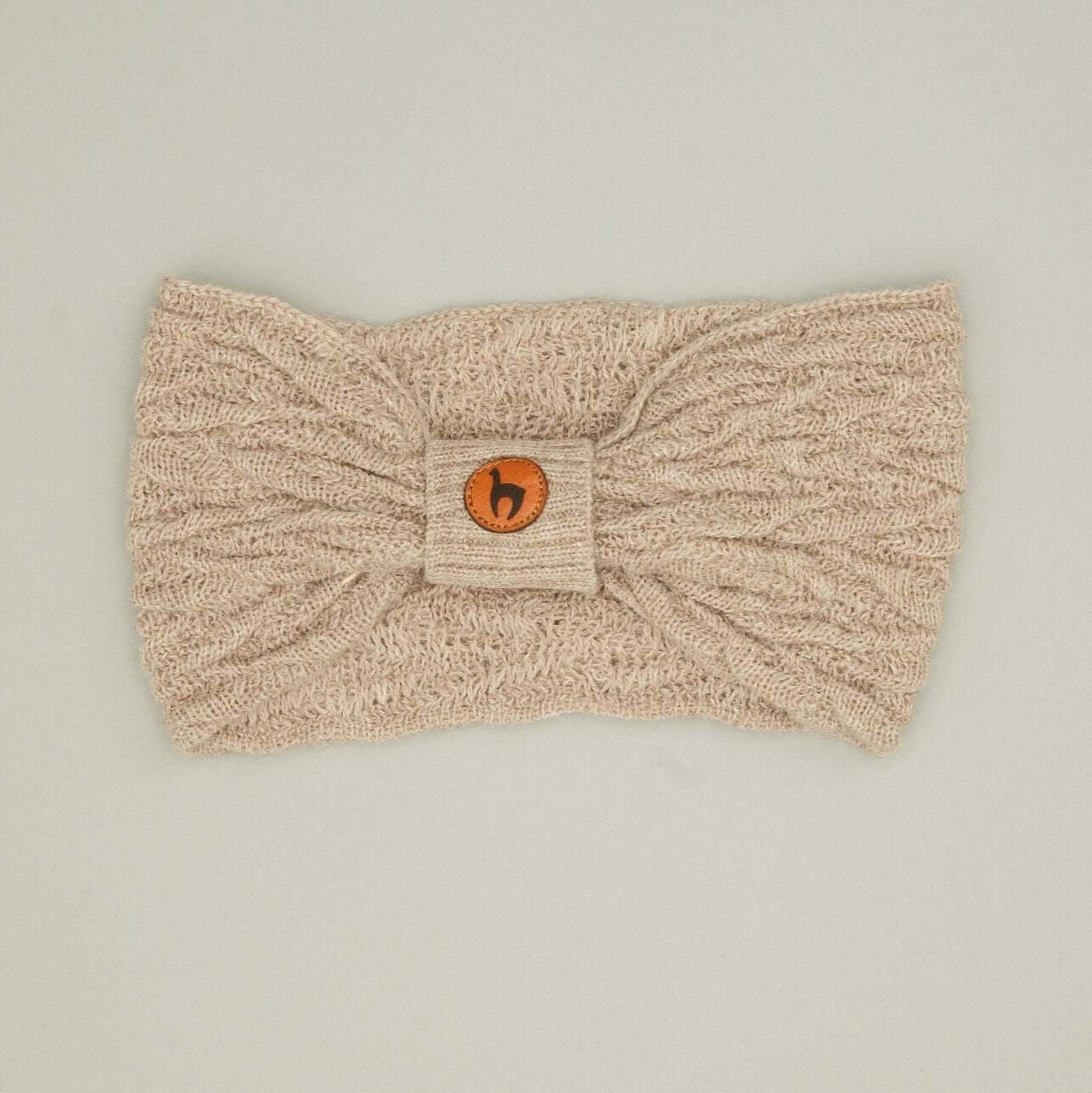 Alpaka Stirnband kaufen, Damenmodell aus 100% Babyalpaka mit Knotendetail in hellbeige.